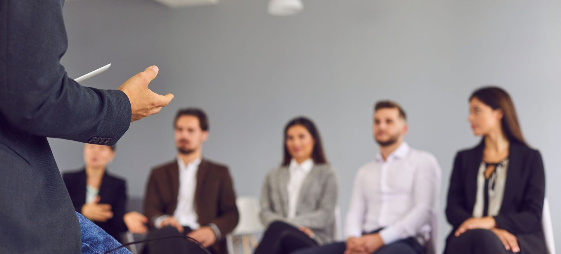 Blog 9 manager sat on desk talking to staff